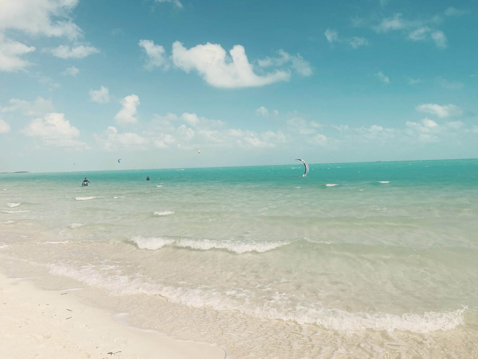 Kiteboarders out on the shallow turquoise water at Long Bay Beach, the island's kiteboarding spot, Providenciales Turks and Caicos