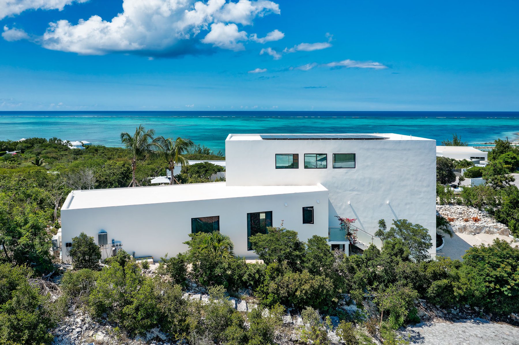 Aerial view of Beachwood Villa overlooking turquoise Caribbean waters in Providenciales — a Canadian March break luxury villa rental in Turks and Caicos