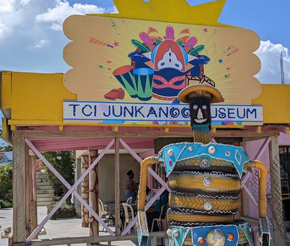 The brightly painted entrance and a tire-sculpture Junkanoo figure at the TCI Junkanoo Museum, Providenciales, Turks and Caicos