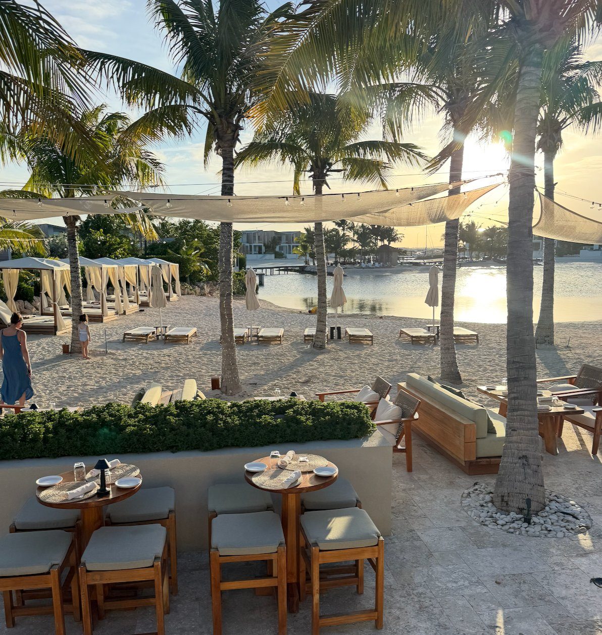 Sunset dinner setting beside the seawater lagoon at Lua Beach House, Long Bay