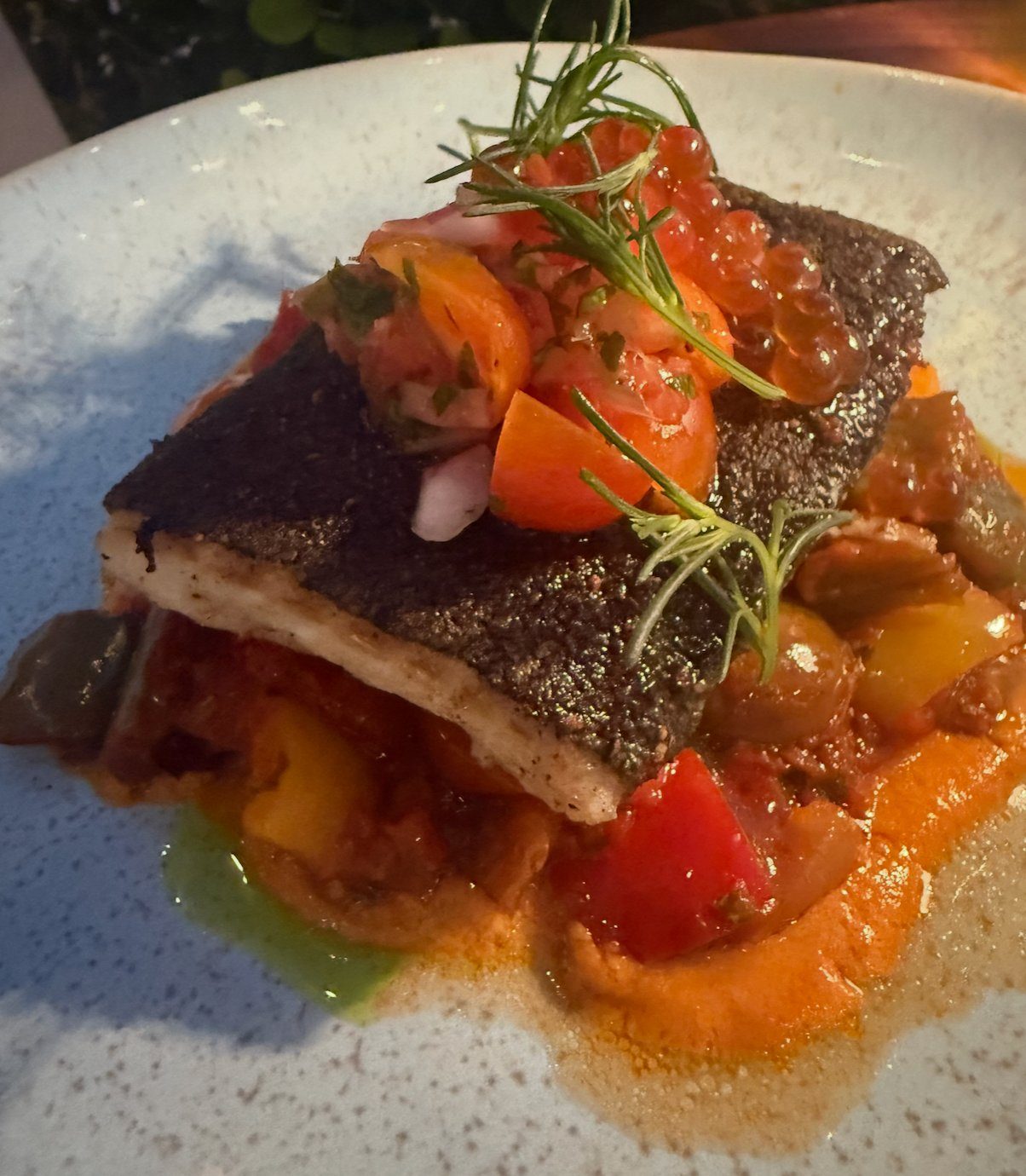 Crisp-skinned fish over ratatouille-style vegetables at Lua Beach House, Turks and Caicos