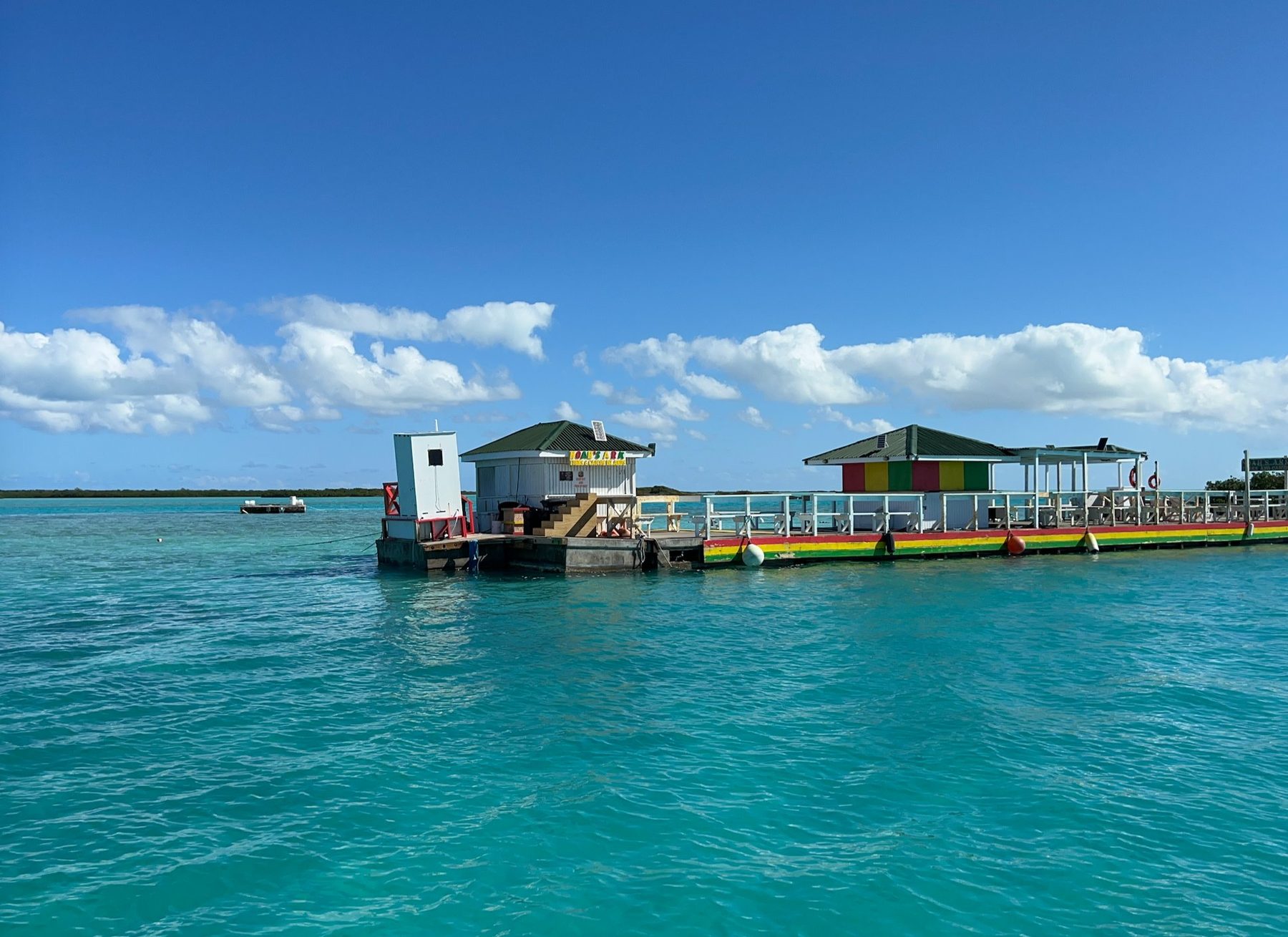 The Noah's Ark floating bar anchored on the shallow turquoise sand flats off Providenciales, Turks and Caicos